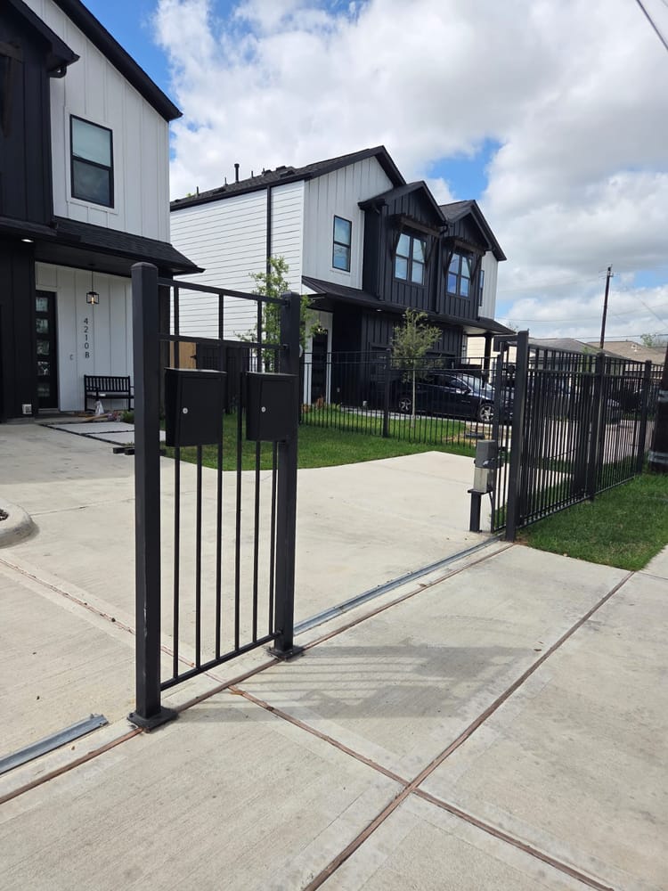 Modern black sliding gate at a new Houston townhome